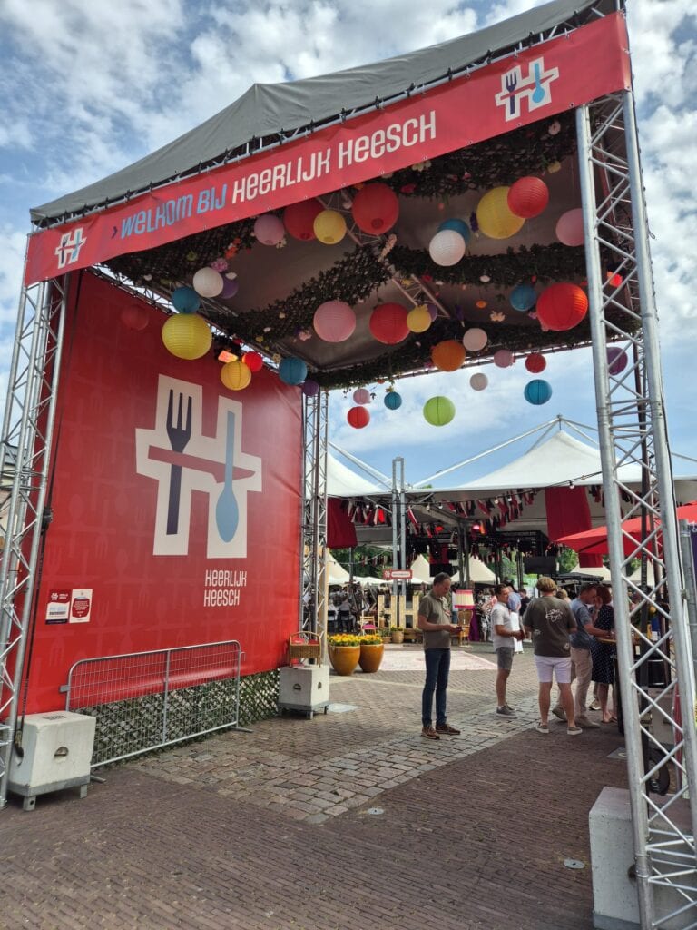 Toegang tot het Heerlijk Heesch festival met kleurrijke ballonnen en feestelijke sfeer.